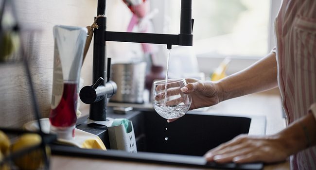 Filling a glass at a kitchen tap