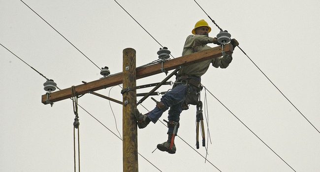 A line worker repairing a power line